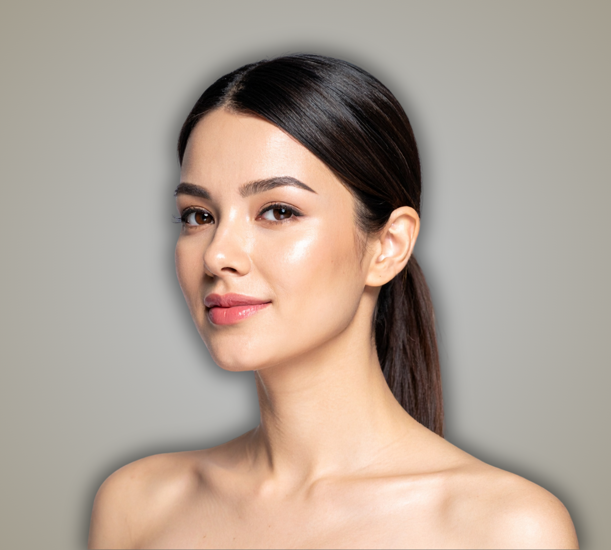 Woman with a ponytail against a plain background on brand of SKN AESTHETICS NZ