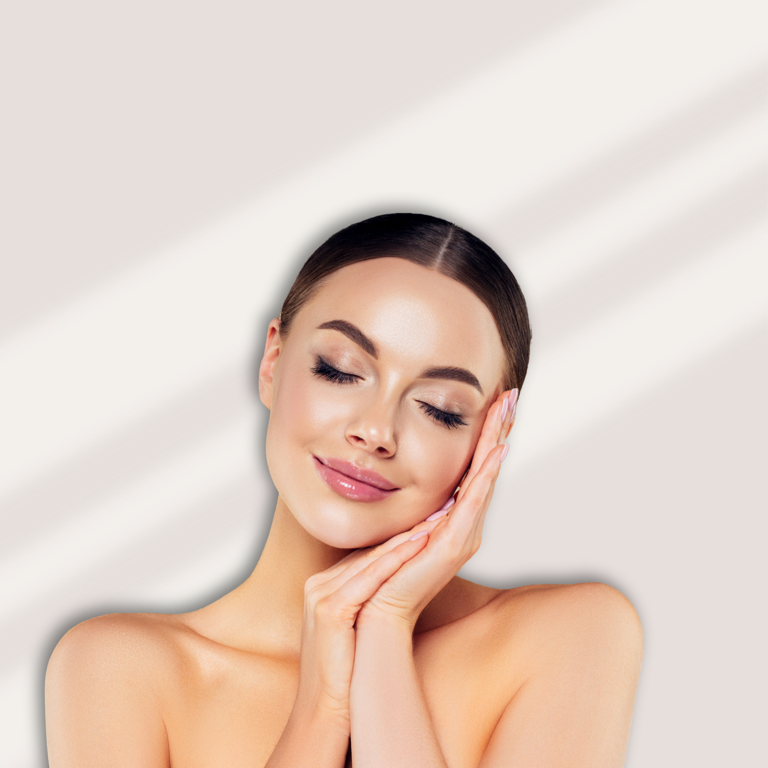 Woman with smooth skin touching her face against a light background